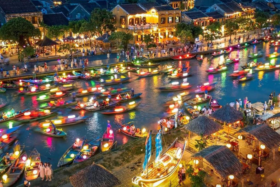 Take a boat ride on the Hoai River and release flower lanterns